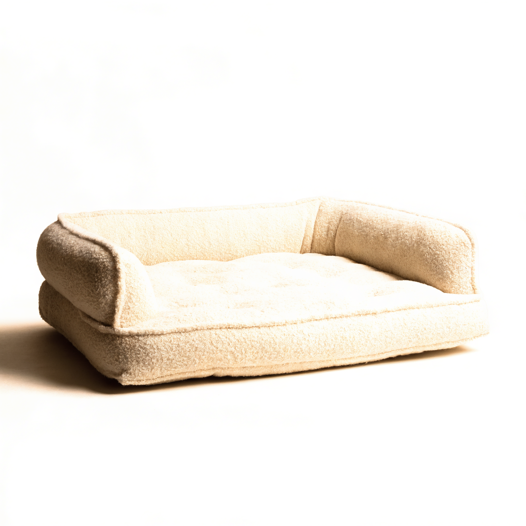 Oatmeal bouclé orthopedic dog bed on warm ivory background