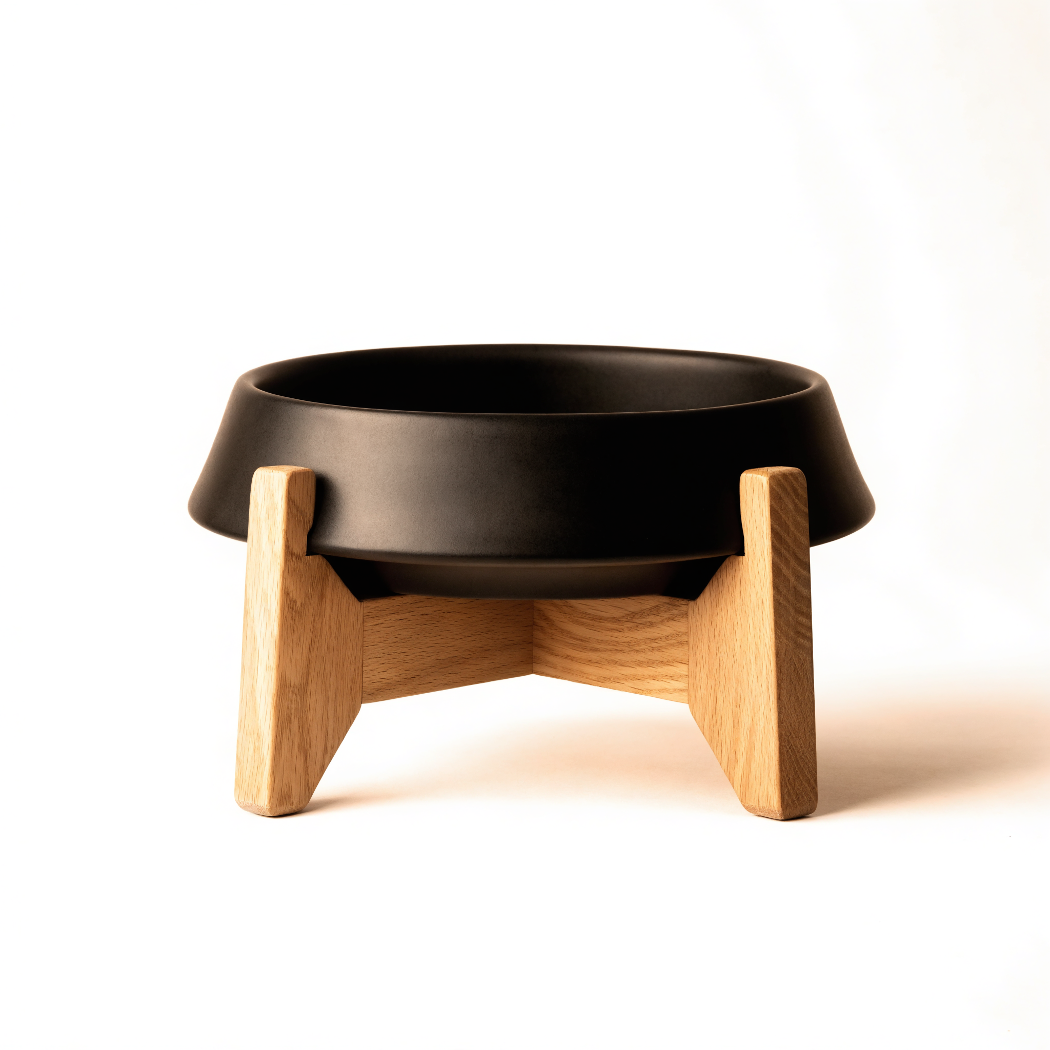 Matte black elevated cat bowl on light oak stand