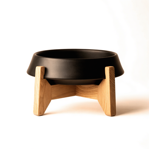 Matte black elevated cat bowl on light oak stand